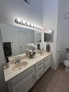 a bathroom with double sink and a mirror