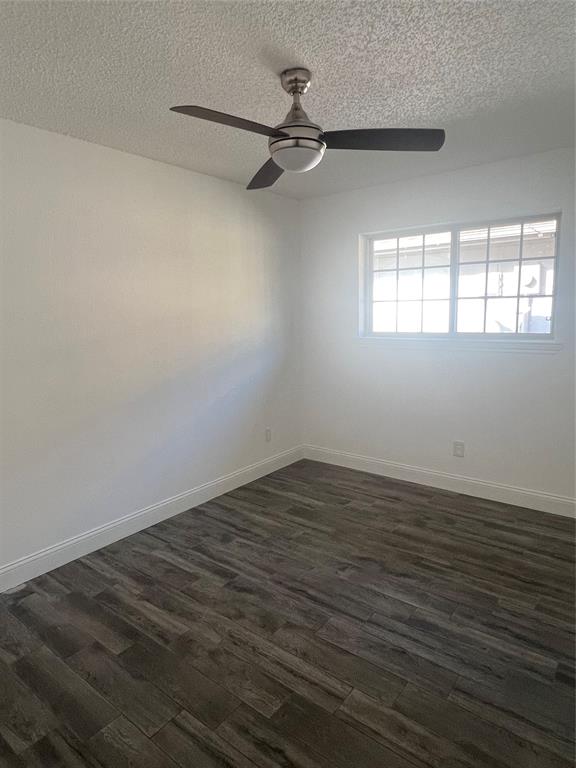 1758 Castille Drive Carrollton, TX 75007 - Photo 15 of 19 a view of a room with wooden floor a ceiling fan and windows