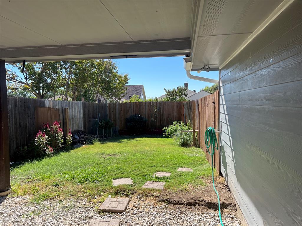 1758 Castille Drive Carrollton, TX 75007 - Photo 17 of 19 a view of a backyard with plants and a garden
