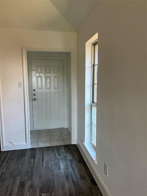 1758 Castille Drive Carrollton, TX 75007 - Photo 2 of 19 an empty room with wooden floor and a window