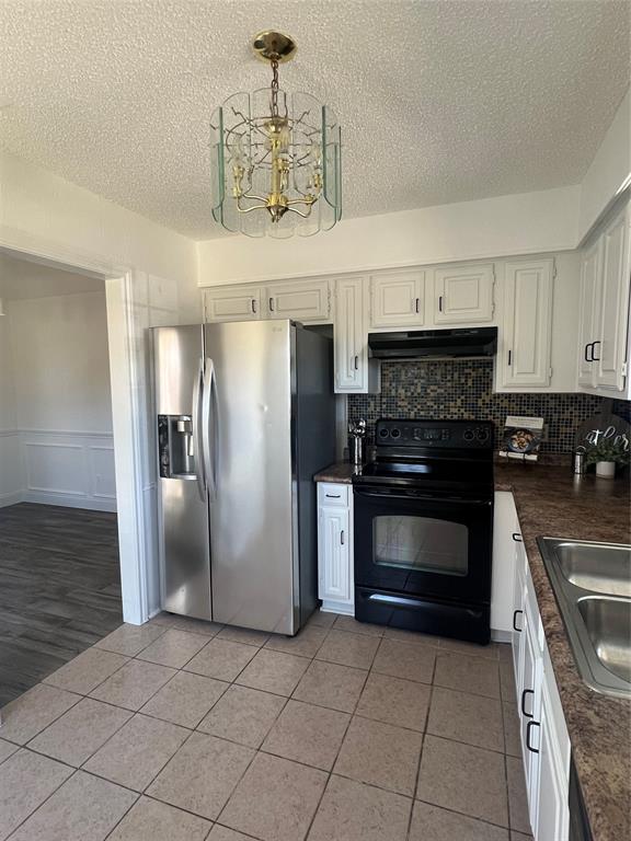 1758 Castille Drive Carrollton, TX 75007 - Photo 7 of 19 a kitchen with granite countertop a refrigerator and a stove top oven