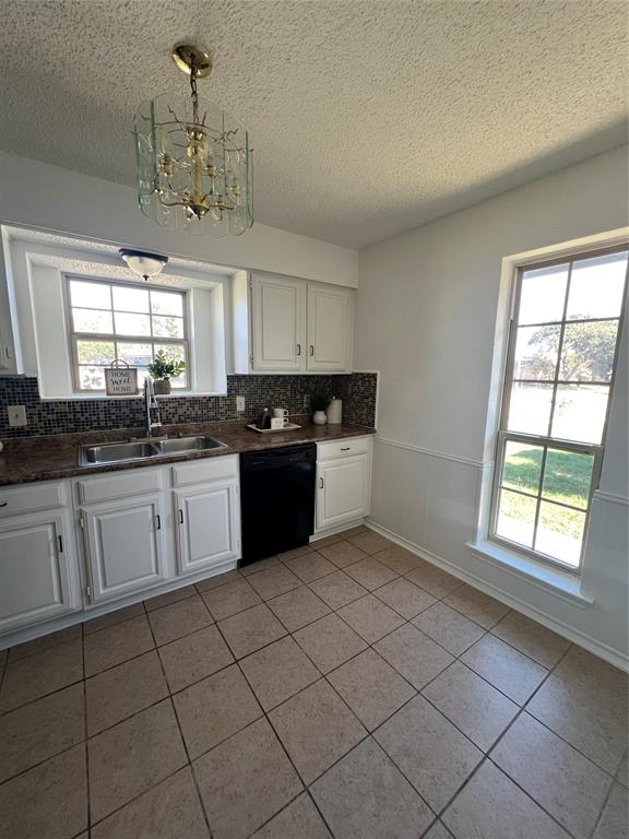 1758 Castille Drive Carrollton, TX 75007 - Photo 10 of 19 a kitchen with a sink window and cabinets