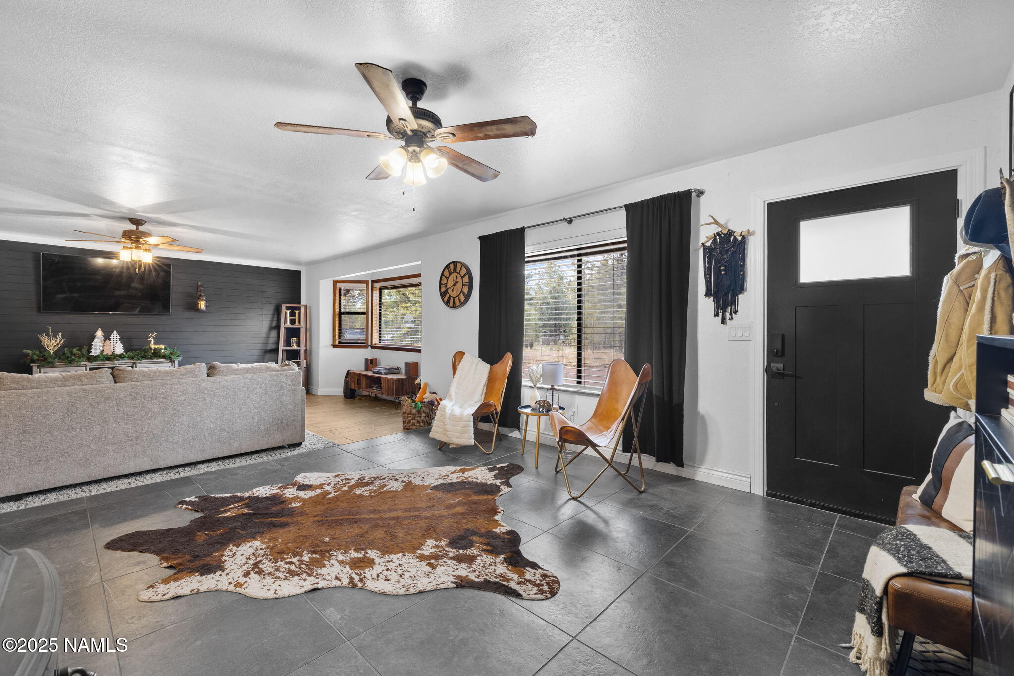 3628 East Pine Cone Drive Williams, AZ 86046 - Photo 1 of 23 a living room with furniture and a flat screen tv