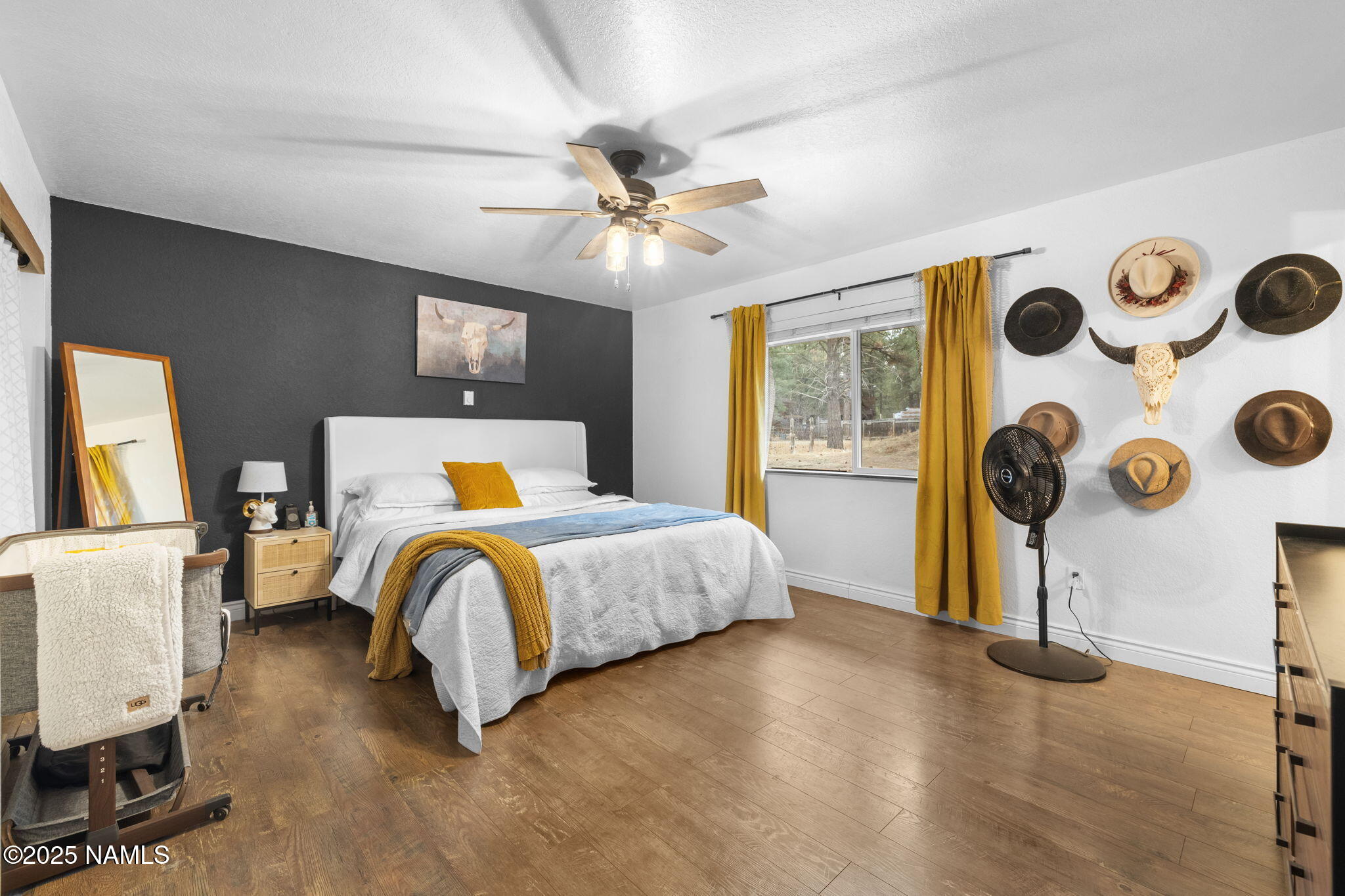 3628 East Pine Cone Drive Williams, AZ 86046 - Photo 13 of 23 a bedroom with a bed and wooden floor