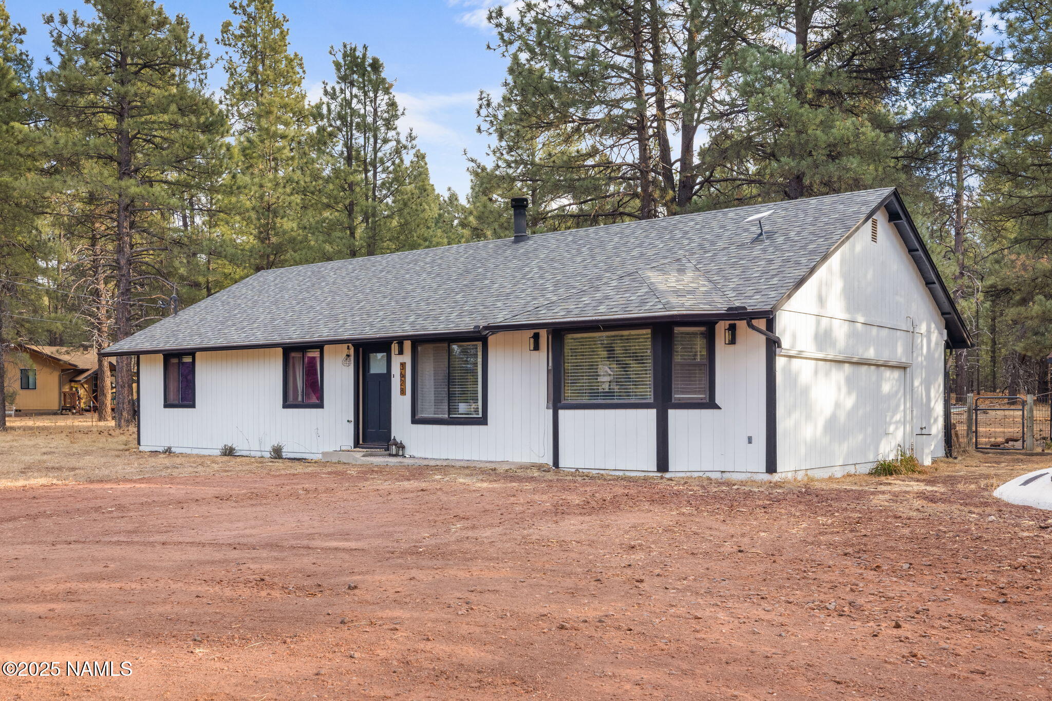3628 East Pine Cone Drive Williams, AZ 86046 - Photo 20 of 23 a house with trees in front of it