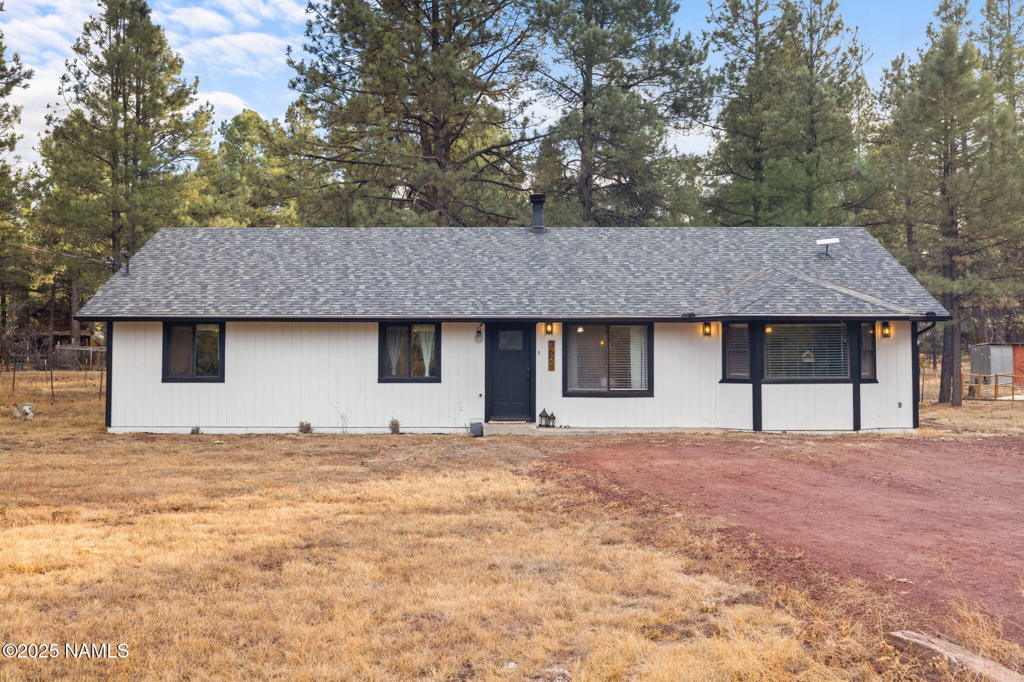 3628 East Pine Cone Drive Williams, AZ 86046 - Photo 21 of 23 a house that has a tree in front of it