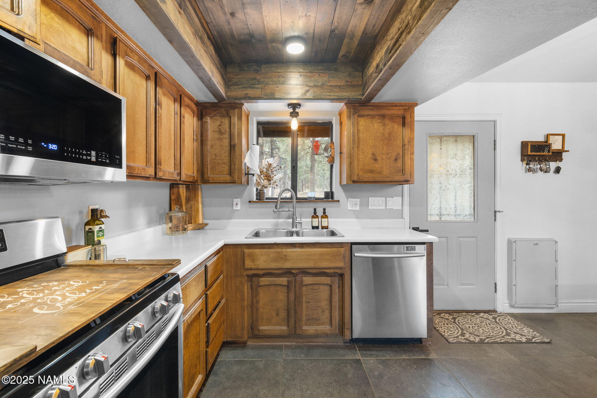 3628 East Pine Cone Drive Williams, AZ 86046 - Photo 3 of 23 a kitchen with a sink stove and microwave