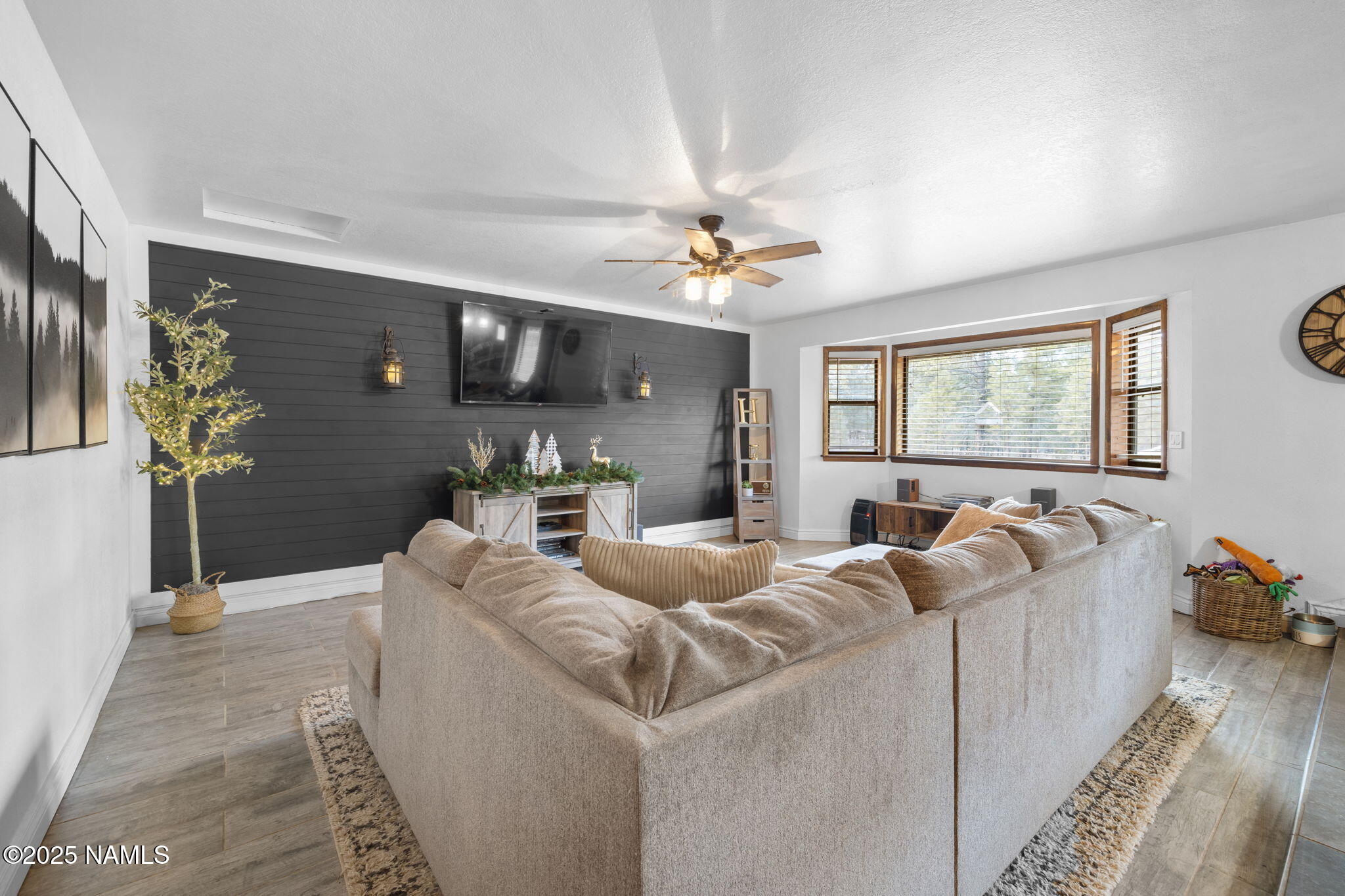 3628 East Pine Cone Drive Williams, AZ 86046 - Photo 7 of 23 a living room with furniture and a flat screen tv