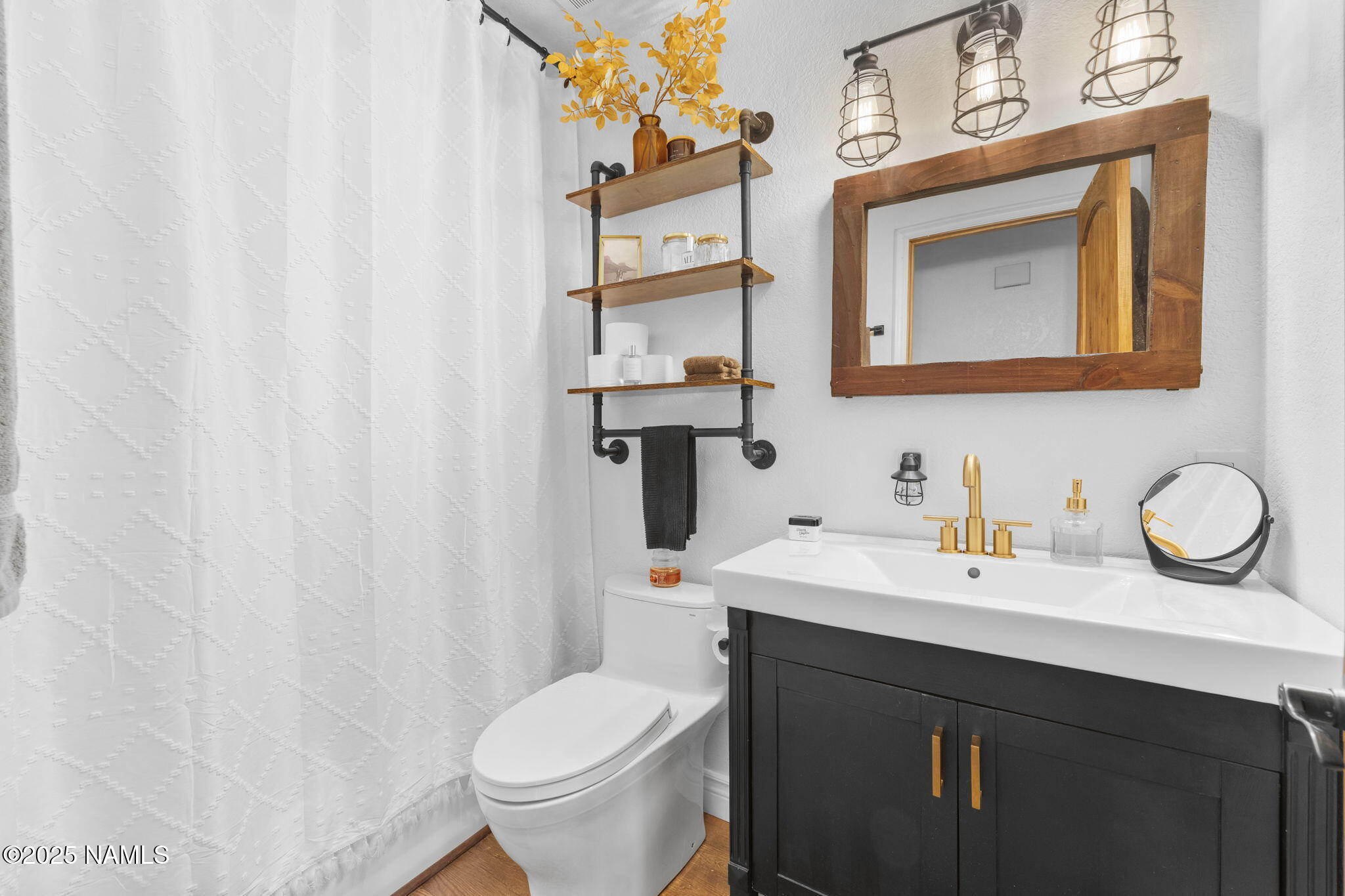 3628 East Pine Cone Drive Williams, AZ 86046 - Photo 9 of 23 a bathroom with a sink vanity and a toilet