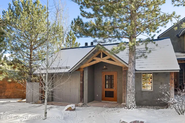 a view of an empty room with a window and a fireplace