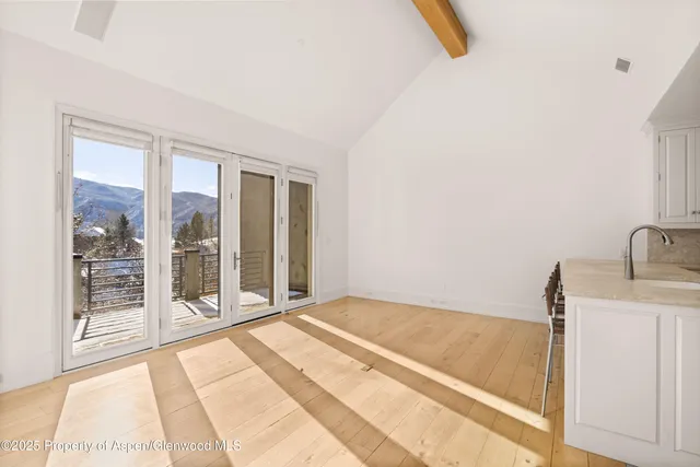 a living room with hardwood floor and a flat screen tv