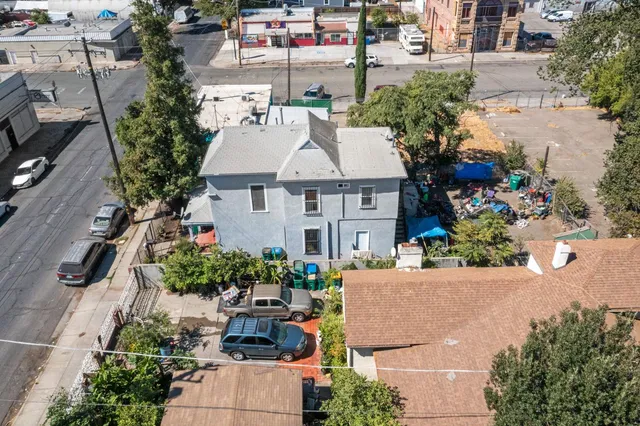 an aerial view of a house with a yard and lake view