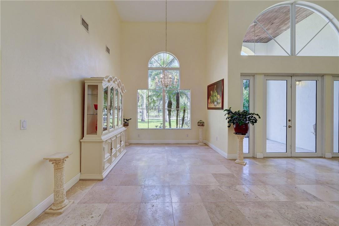 17400 Southwest 66th Street Southwest Ranches, FL 33331 - Photo 12 of 38 a view of a hallway with windows and chandelier