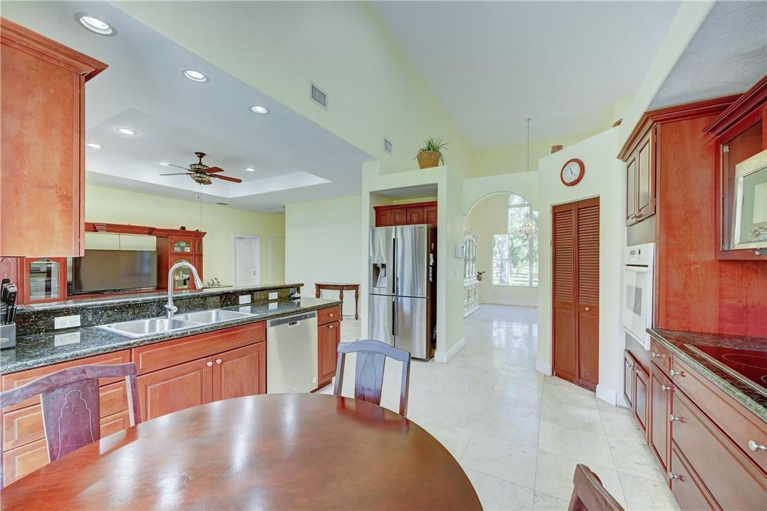 17400 Southwest 66th Street Southwest Ranches, FL 33331 - Photo 15 of 38 a kitchen with stainless steel appliances granite countertop a sink and cabinets
