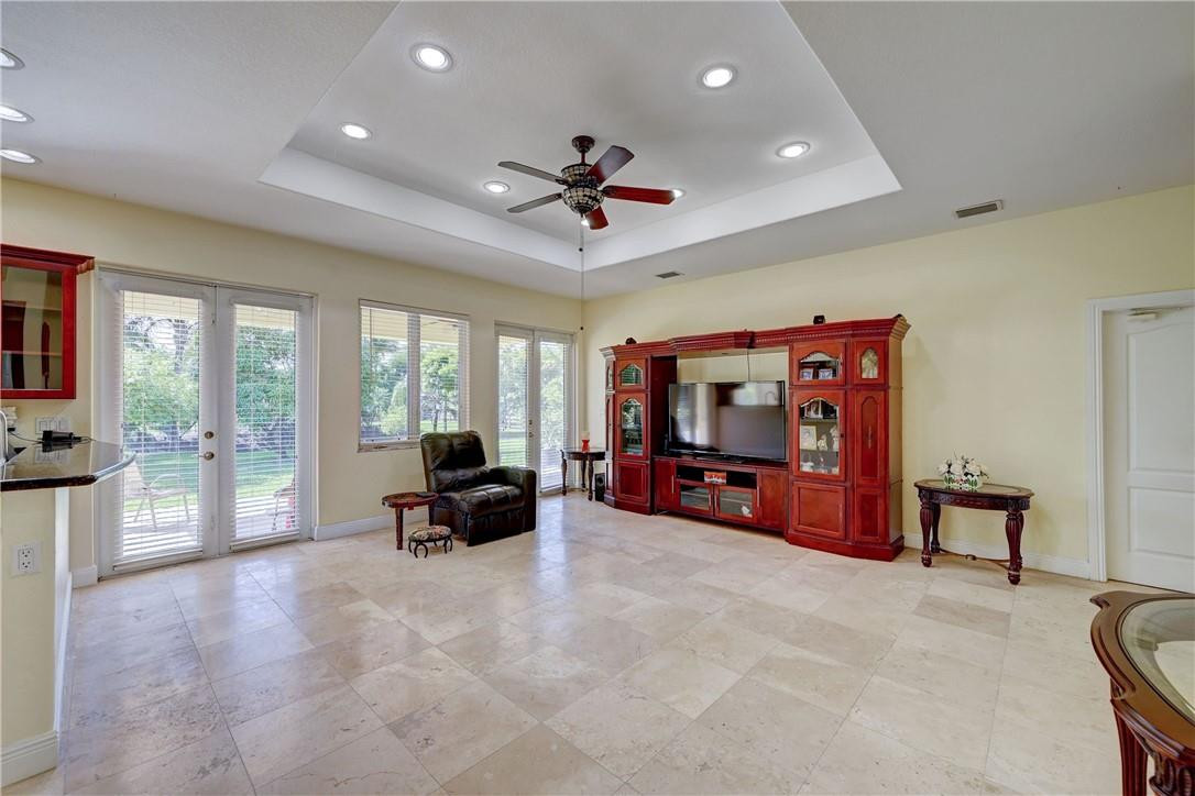 17400 Southwest 66th Street Southwest Ranches, FL 33331 - Photo 17 of 38 a living room with furniture gym equipment and a large window
