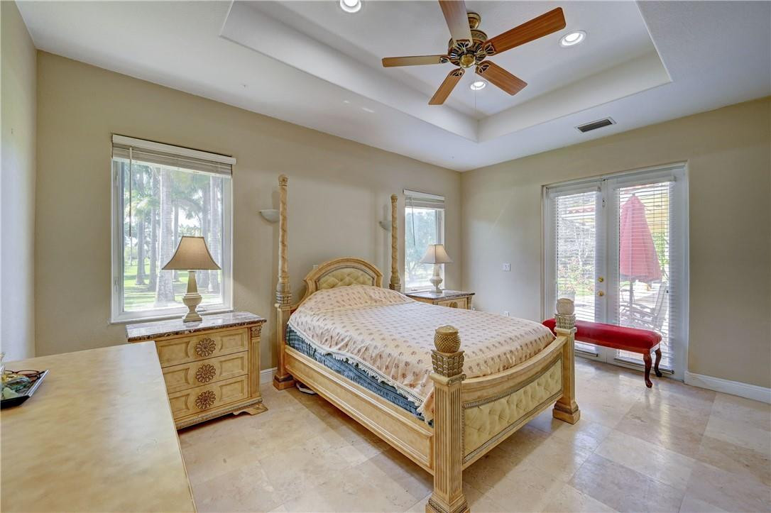 17400 Southwest 66th Street Southwest Ranches, FL 33331 - Photo 21 of 38 a bed sitting in a spacious bedroom next to a window