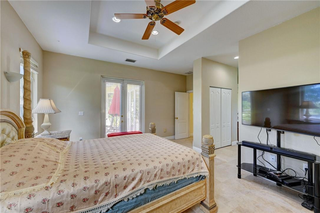 17400 Southwest 66th Street Southwest Ranches, FL 33331 - Photo 22 of 38 a bedroom with a bed and a flat screen tv