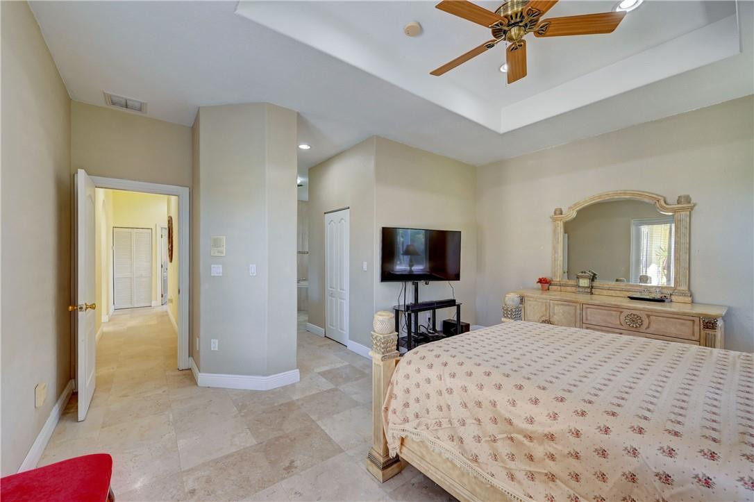 17400 Southwest 66th Street Southwest Ranches, FL 33331 - Photo 23 of 38 a bedroom with a bed and a flat screen tv