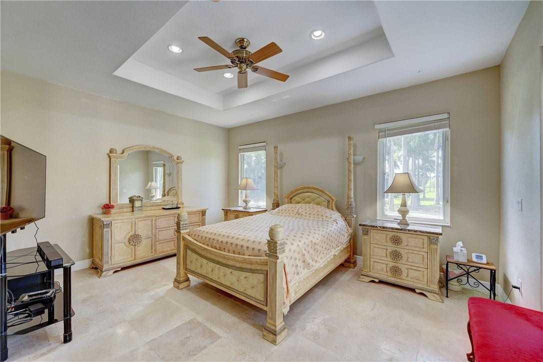 17400 Southwest 66th Street Southwest Ranches, FL 33331 - Photo 24 of 38 a spacious bedroom with a bed and a chandelier