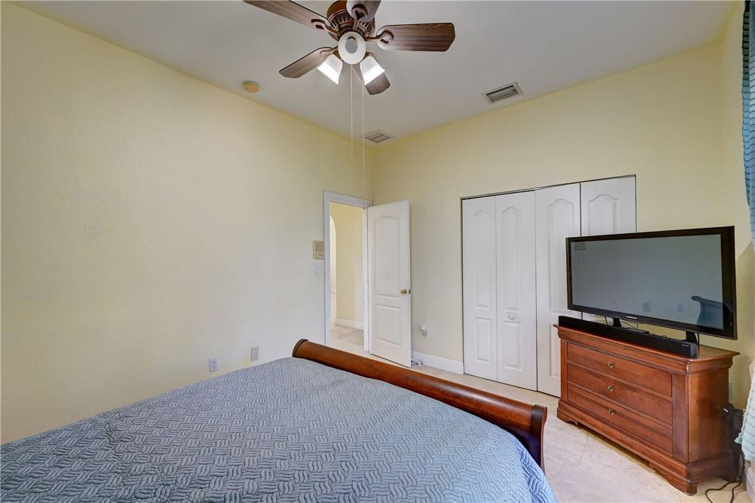 17400 Southwest 66th Street Southwest Ranches, FL 33331 - Photo 27 of 38 a bedroom with a bed and a flat screen tv