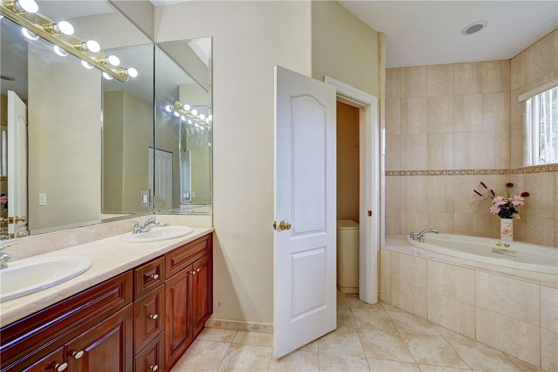 17400 Southwest 66th Street Southwest Ranches, FL 33331 - Photo 31 of 38 a bathroom with a tub sink and mirror