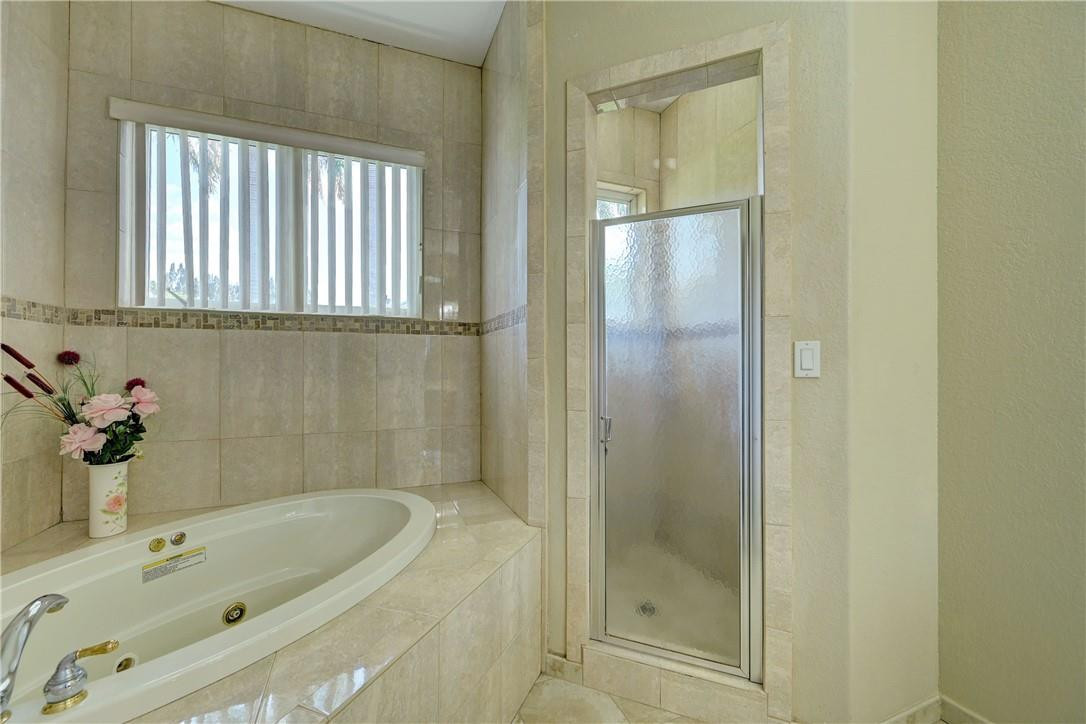 17400 Southwest 66th Street Southwest Ranches, FL 33331 - Photo 32 of 38 a bathroom with a tub shower and a sink