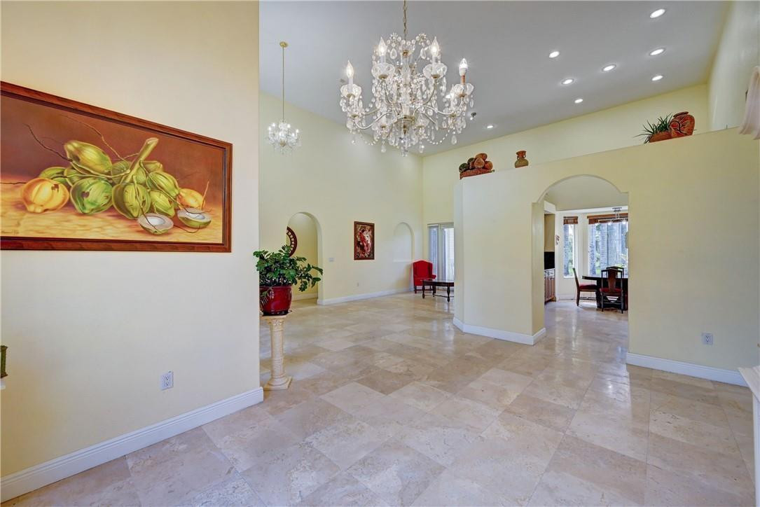 17400 Southwest 66th Street Southwest Ranches, FL 33331 - Photo 10 of 38 a view of a room with furniture and a chandelier