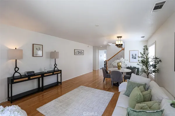 a living room with furniture rug and wooden floor
