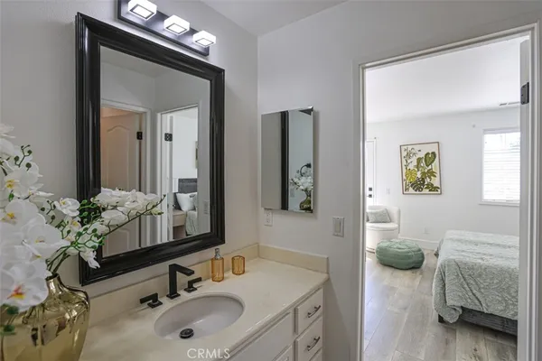 a en suite bathroom with 2 sink and a mirror