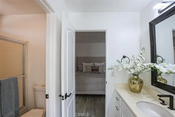 a en suite bathroom with a granite countertop double vanity