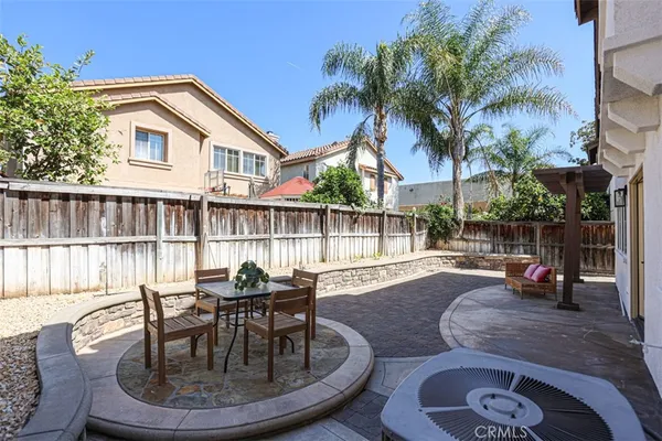 a view of a house with backyard and sitting area