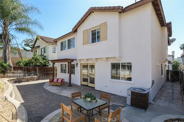 a view of a house with backyard and sitting area