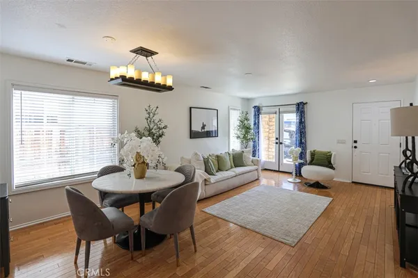 a living room with furniture wooden floor and a chandelier