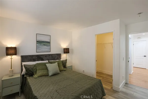 a bedroom with a bed and a night stand