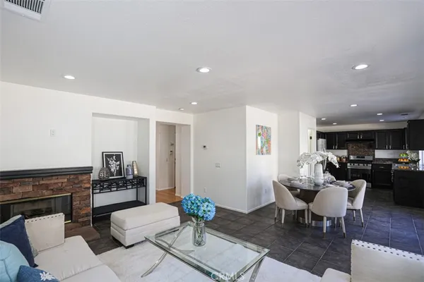 a living room with furniture and kitchen view