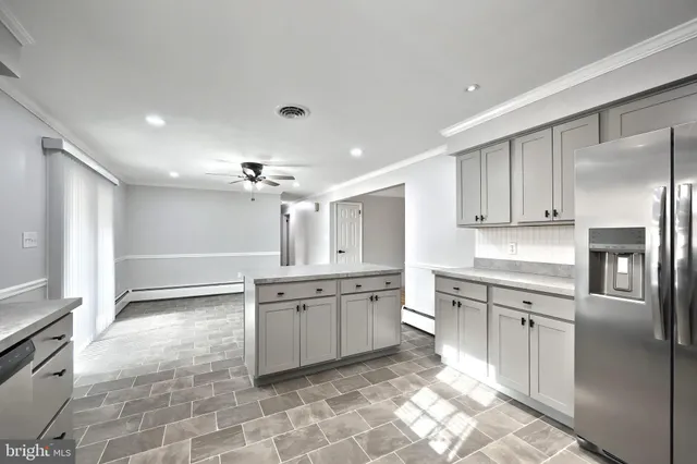 a large kitchen with cabinets and stainless steel appliances
