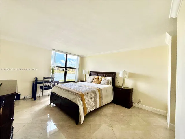 a spacious bedroom with a bed and window