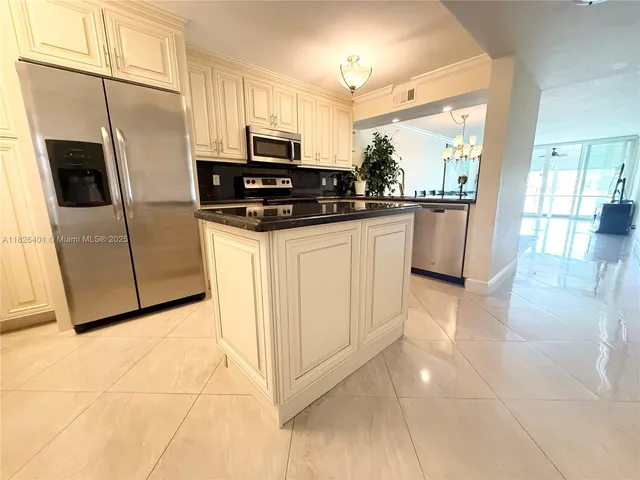 a kitchen with stainless steel appliances a refrigerator sink and microwave