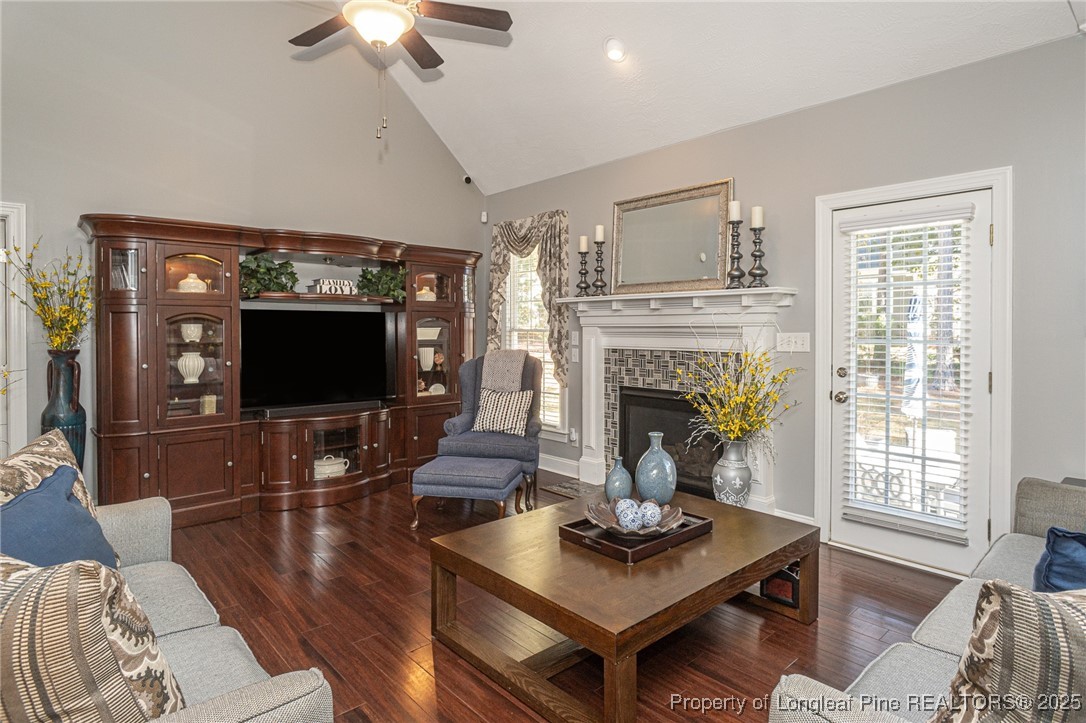595 Whispering Pines Drive Spring Lake, NC 28390 - Photo 11 of 48 a living room with furniture a flat screen tv and a fireplace