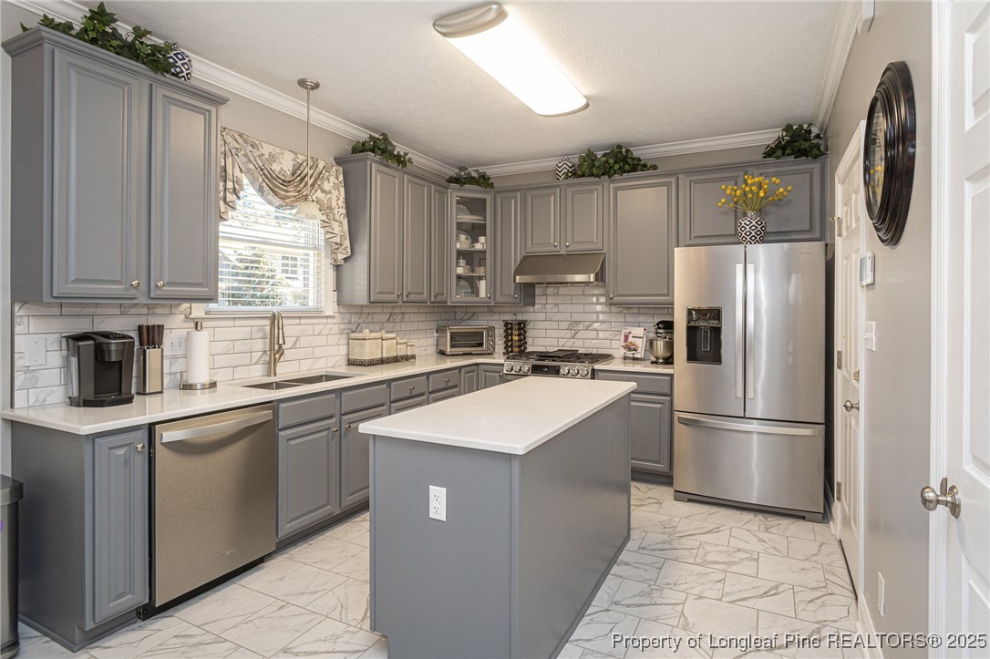 595 Whispering Pines Drive Spring Lake, NC 28390 - Photo 13 of 48 a kitchen with kitchen island a sink appliances cabinets and a counter top space