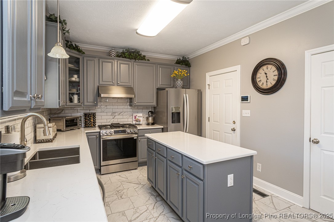 595 Whispering Pines Drive Spring Lake, NC 28390 - Photo 14 of 48 a kitchen with stainless steel appliances granite countertop a refrigerator a stove and a sink