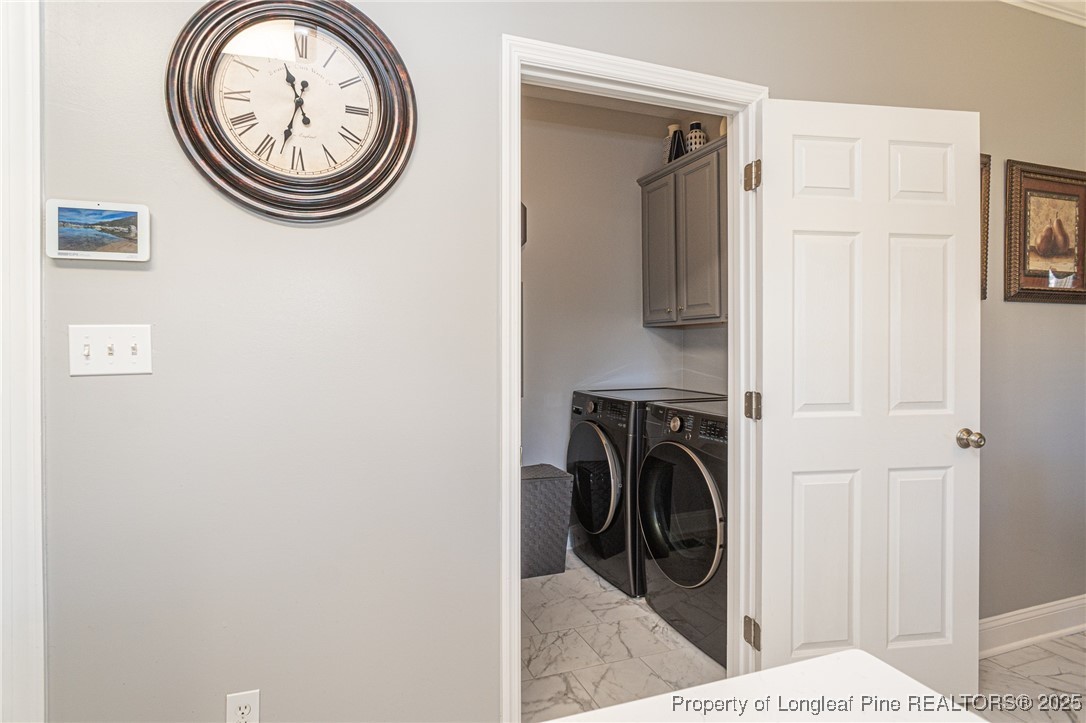 595 Whispering Pines Drive Spring Lake, NC 28390 - Photo 18 of 48 a view of a hallway with washer and dryer