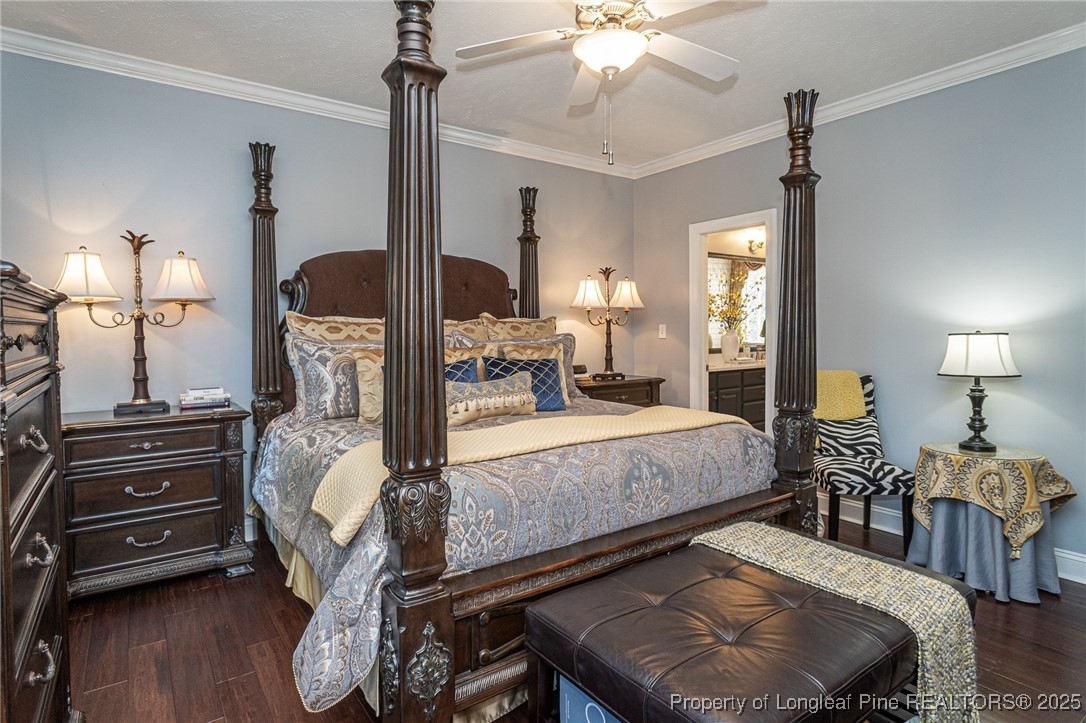 595 Whispering Pines Drive Spring Lake, NC 28390 - Photo 20 of 48 a bed room with furniture and wooden floor