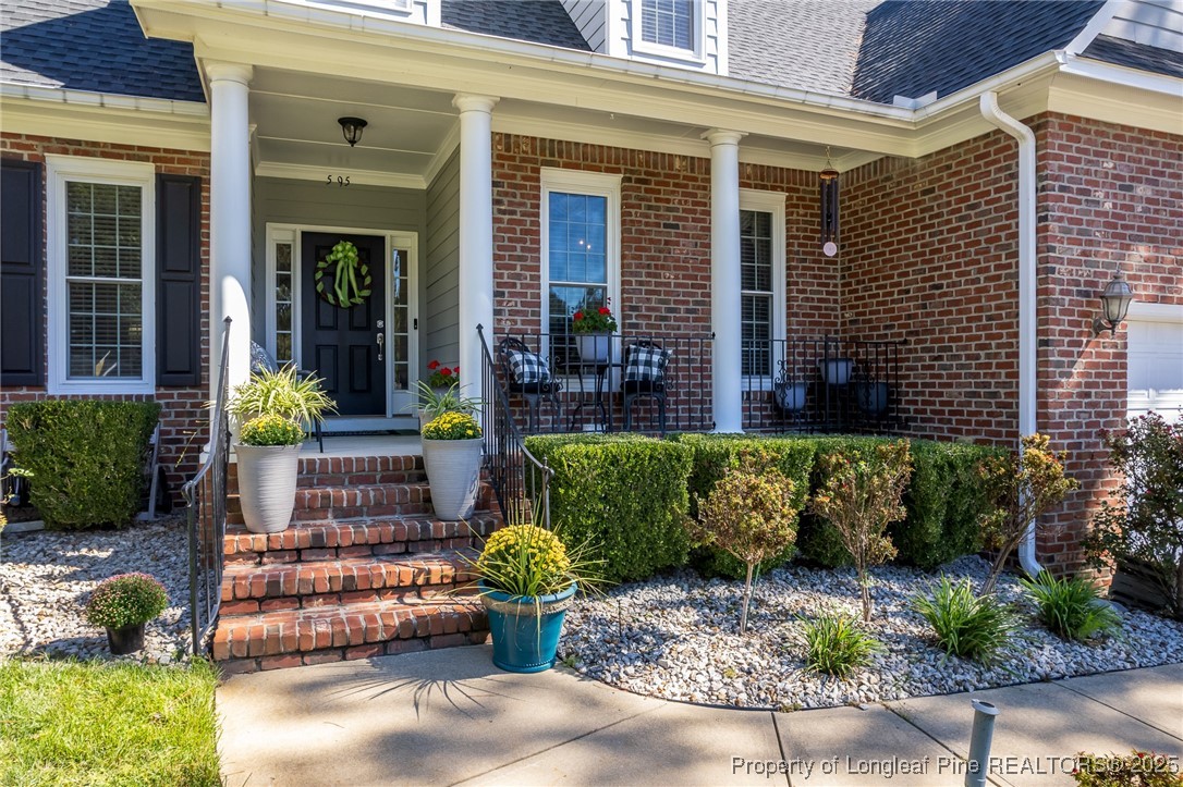 595 Whispering Pines Drive Spring Lake, NC 28390 - Photo 2 of 48 a view of a house with a chairs in a patio