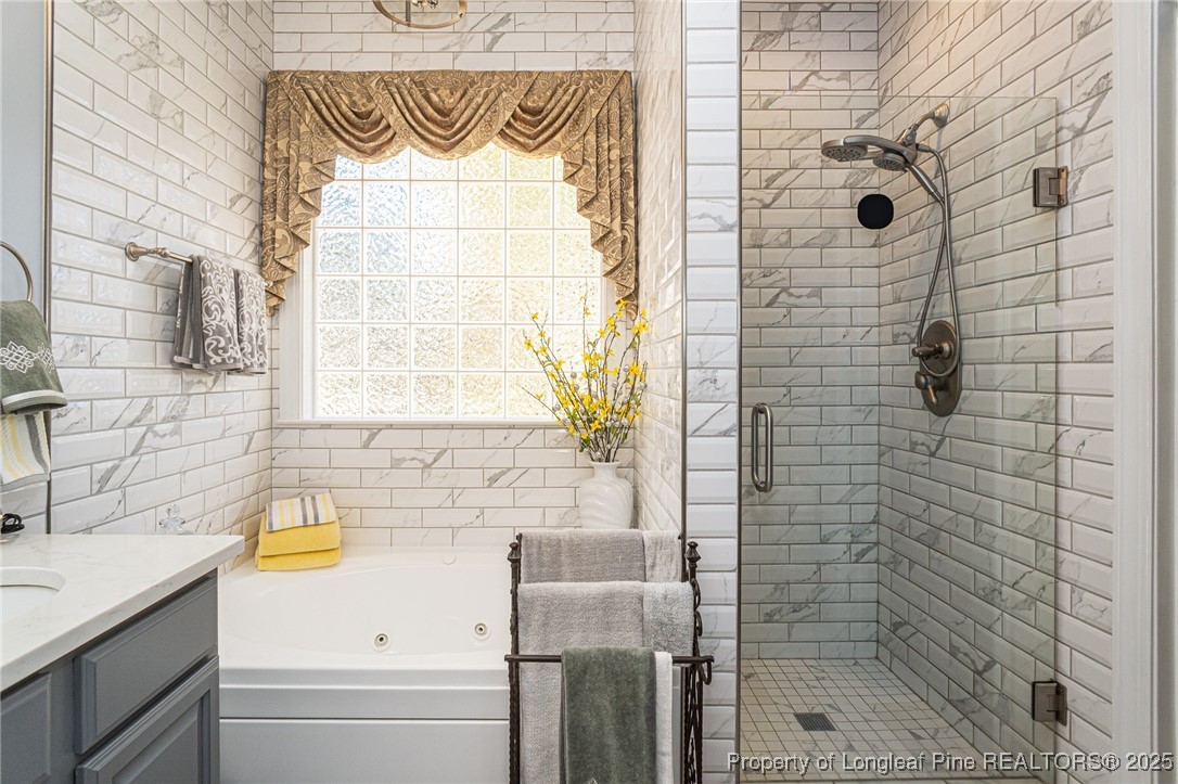 595 Whispering Pines Drive Spring Lake, NC 28390 - Photo 23 of 48 a bathroom with a bathtub and a sink