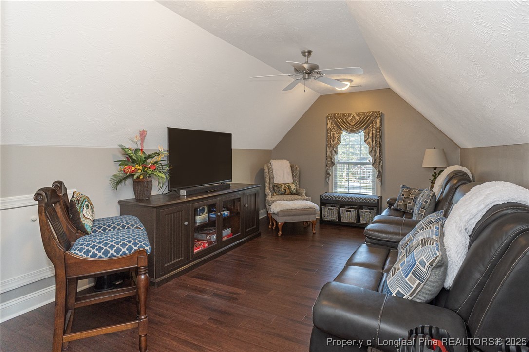 595 Whispering Pines Drive Spring Lake, NC 28390 - Photo 29 of 48 a living room with furniture a chandelier and a flat screen tv
