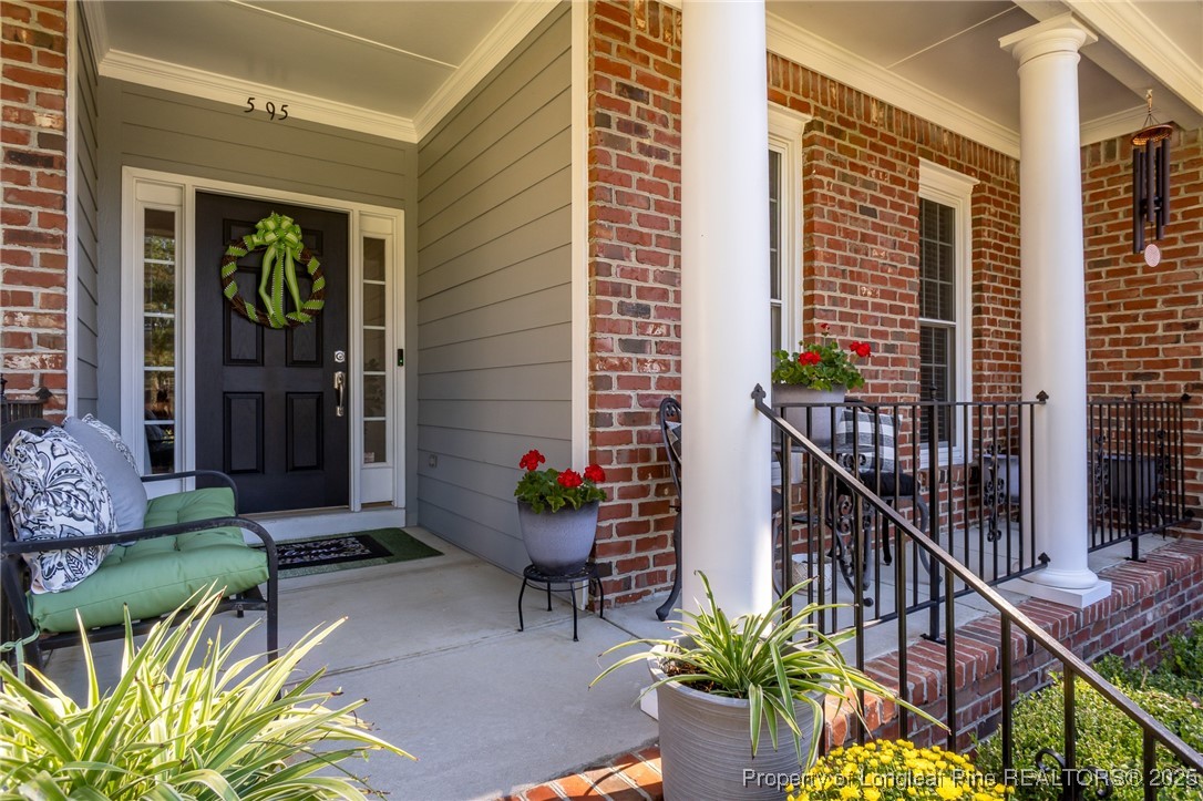 595 Whispering Pines Drive Spring Lake, NC 28390 - Photo 3 of 48 a balcony with furniture and a potted plant