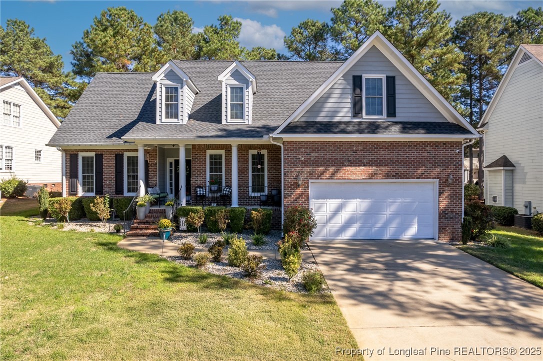 595 Whispering Pines Drive Spring Lake, NC 28390 - Photo 35 of 48 a front view of a house with swimming pool and porch