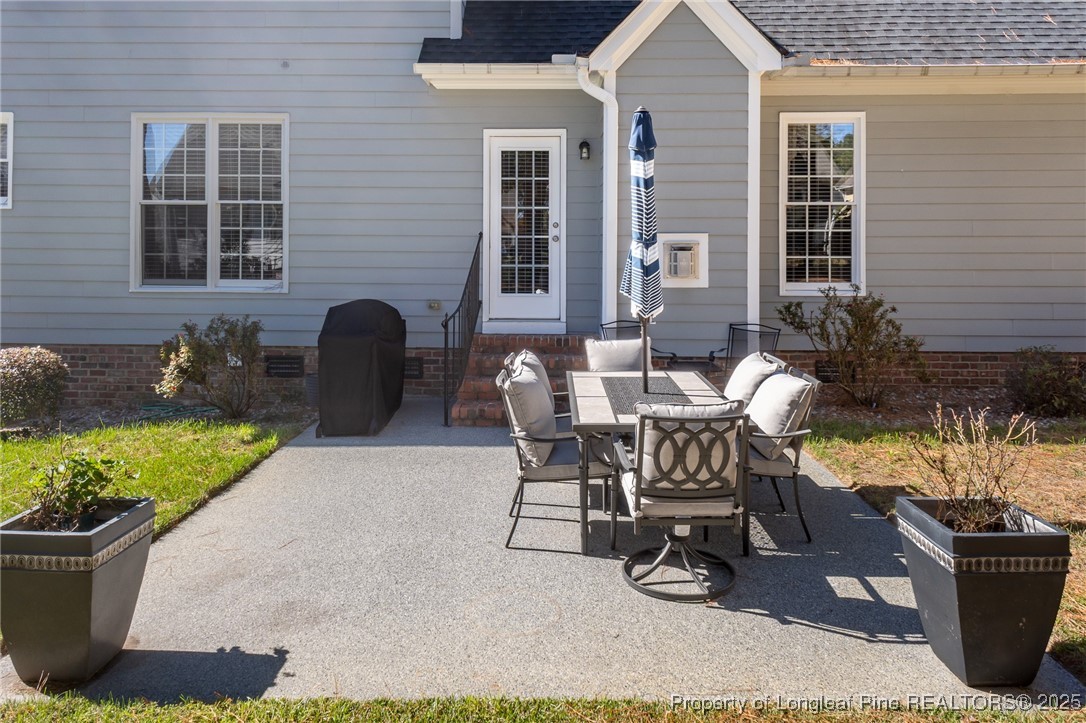 595 Whispering Pines Drive Spring Lake, NC 28390 - Photo 37 of 48 a view of a house with patio and a yard