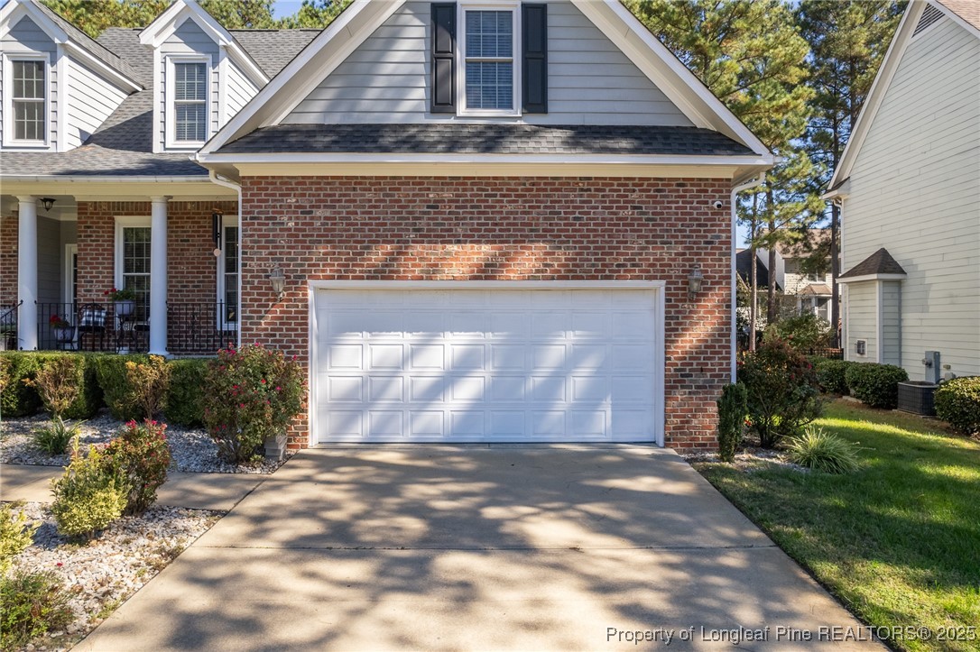 595 Whispering Pines Drive Spring Lake, NC 28390 - Photo 40 of 48 a front view of a house with a yard and garage